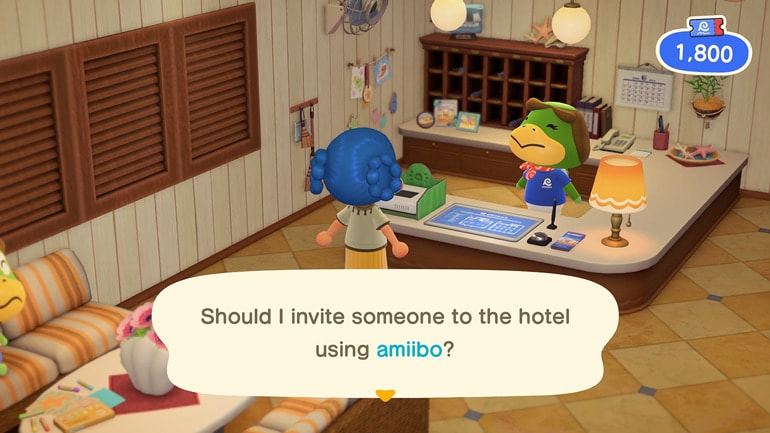 Player at hotel reception desk asks "Should I invite someone to the hotel using amiibo?"